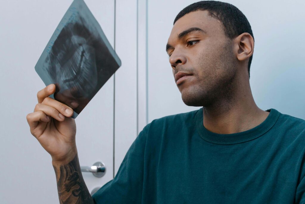 man looking at dental xray