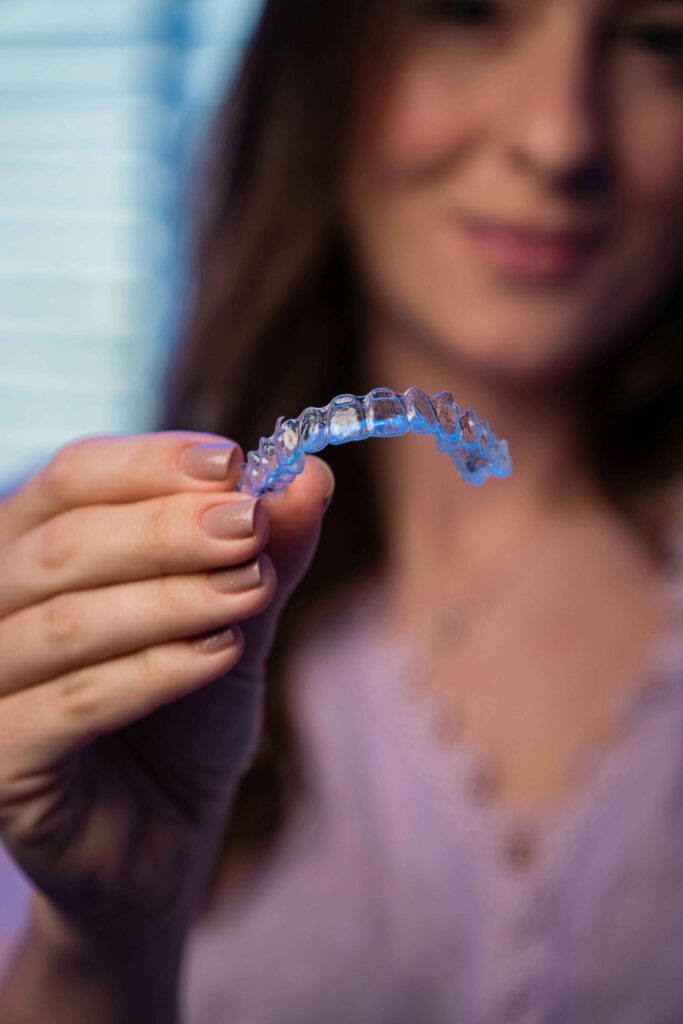 dentist holding a retainer